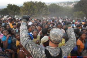 100119-D-1852B-277
PORT-AU-PRINCE, Haiti (Jan. 19, 2010) Army Pfc. Jonathan Pflueger, assigned to the 1st Squadron, 73rd Cavalry Regiment, 82nd Airborne Division, holds his hands above a crowd of women to try to get them to sit down at a humanitarian aid distribution point in Port-au-Prince, Haiti. Units from all branches of the U.S. military are conducting humanitarian and disaster relief operations as part of Operation Unified Response after a 7.0 magnitude earthquake caused severe damage in Haiti Jan. 12. (Department of Defense photo by Fred W. Baker III/Released)