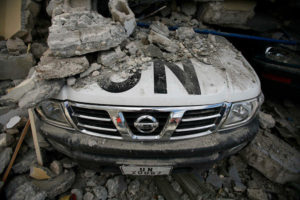 A UN car is covered in rubble the day after an earthquake†hit Port-au-Prince, Haiti, Wednesday, Jan. 13, 2010. The 7.0-magnitude earthquake that hit Haiti on Tuesday flattened the president's palace, the cathedral, hospitals, schools, the main prison and whole neighborhoods. (AP Photo/Ricardo Arduengo)