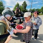 Delivering food to front line recaptured villages and receiving strawberries from locals.